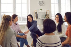 A group of women participate in a support group, one of the best relapse prevention techniques.