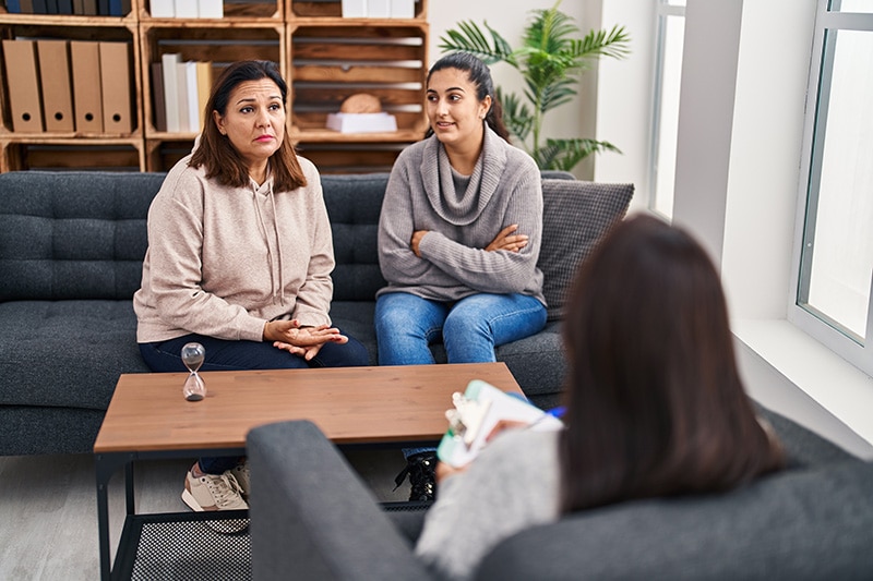 A family participates in family therapy as part of a mental health treatment program.