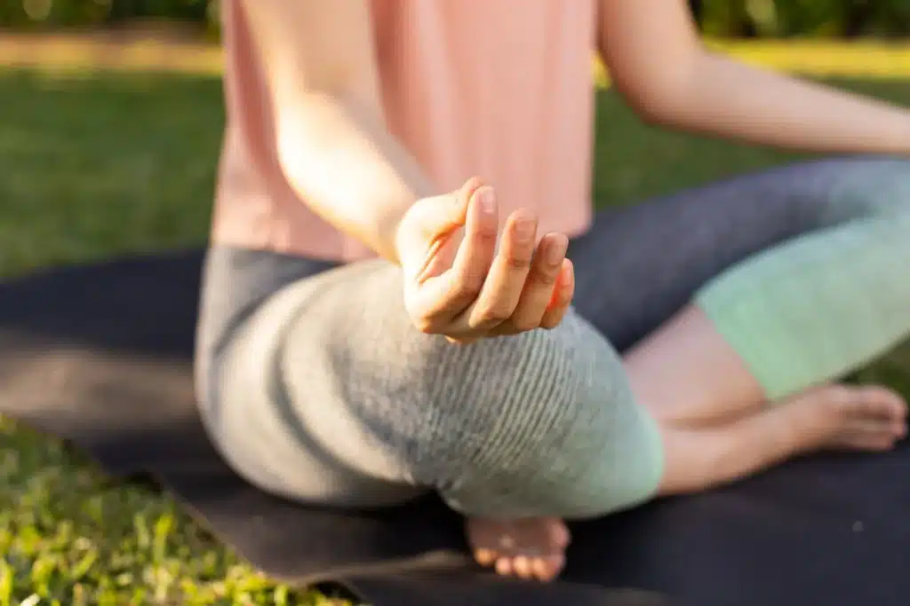 A woman practices meditation in recovery.