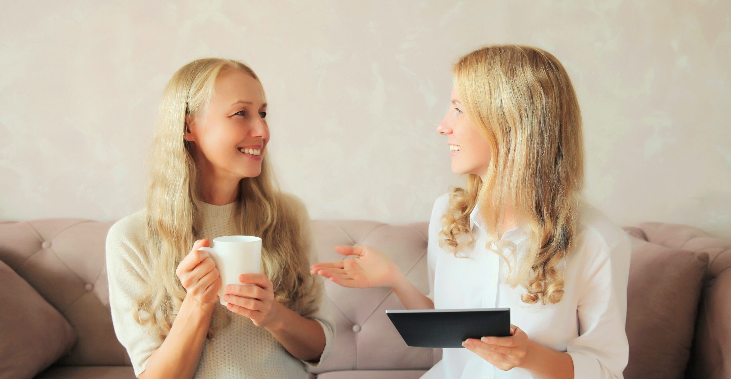 Two women talking on a couch about drug rehab in michigan.