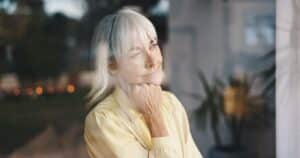 middle aged woman thoughtful window perimenopause and alcohol abuse